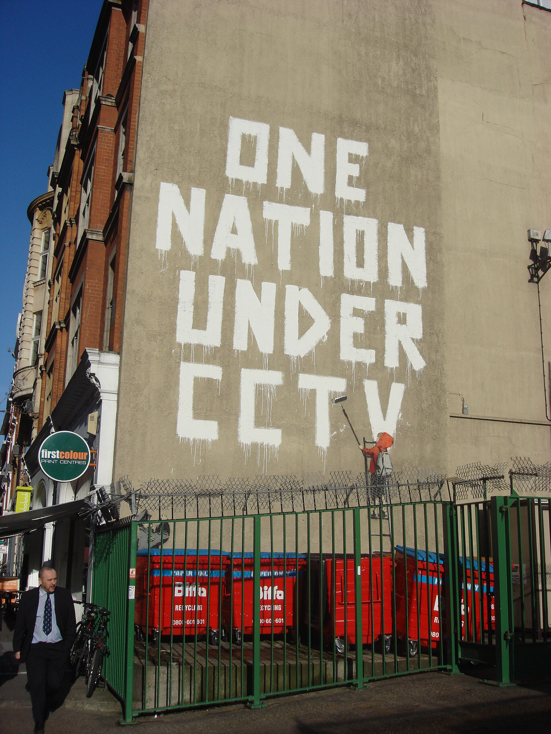 One Nation Under CCTV — Banksy's three-storey 2008 mural opposite a working CCTV camera in Newman Street, London. Painted directly behind the camera that recorded its making, the work was destroyed by Westminster City Council in 2009.