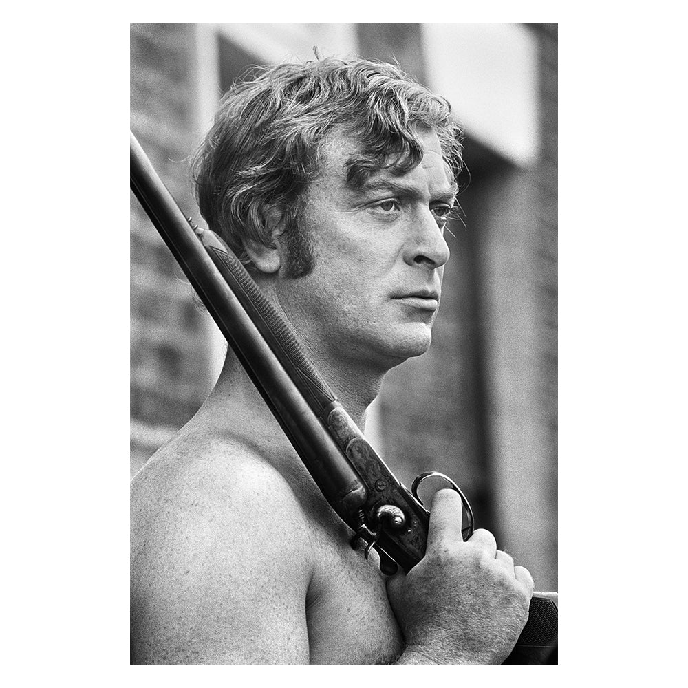 Michael Caine holding a rifle, 1970