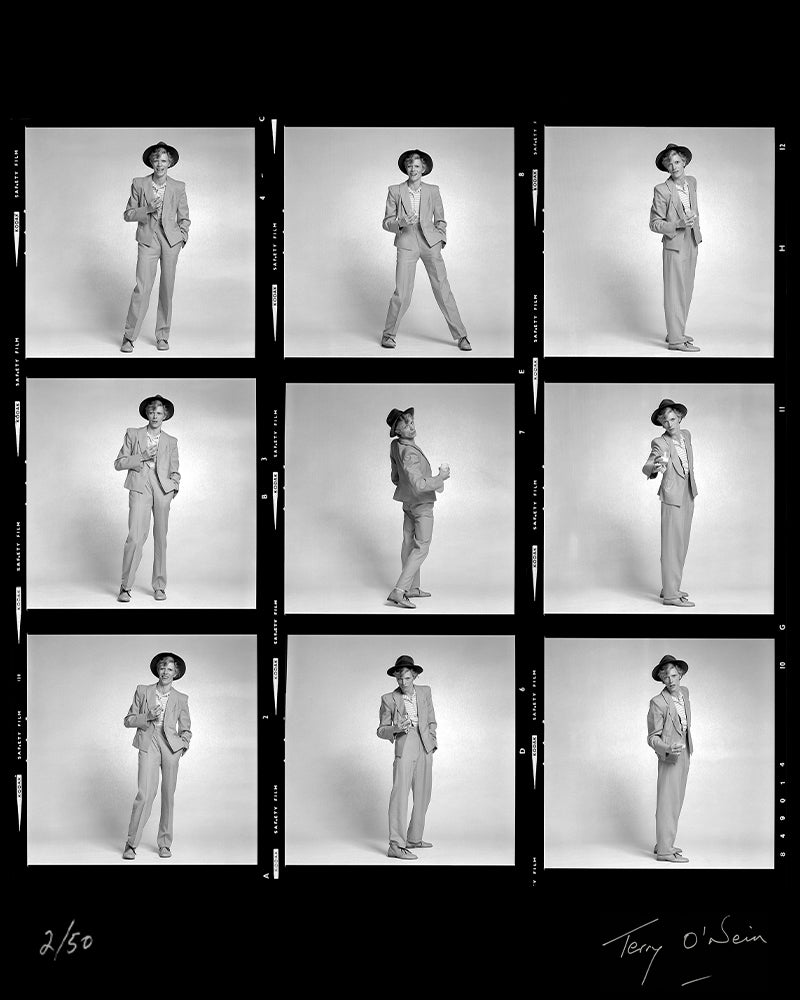 David Bowie holding a glass contact sheet, 1974