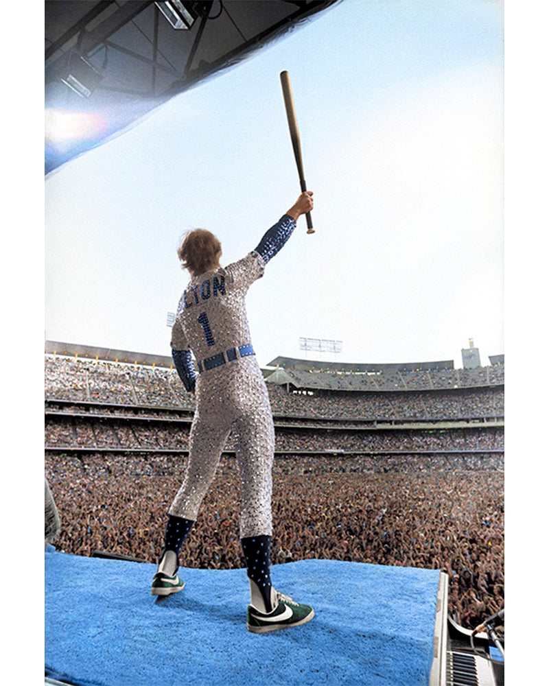 Elton John standing on a piano (colorized), 1975