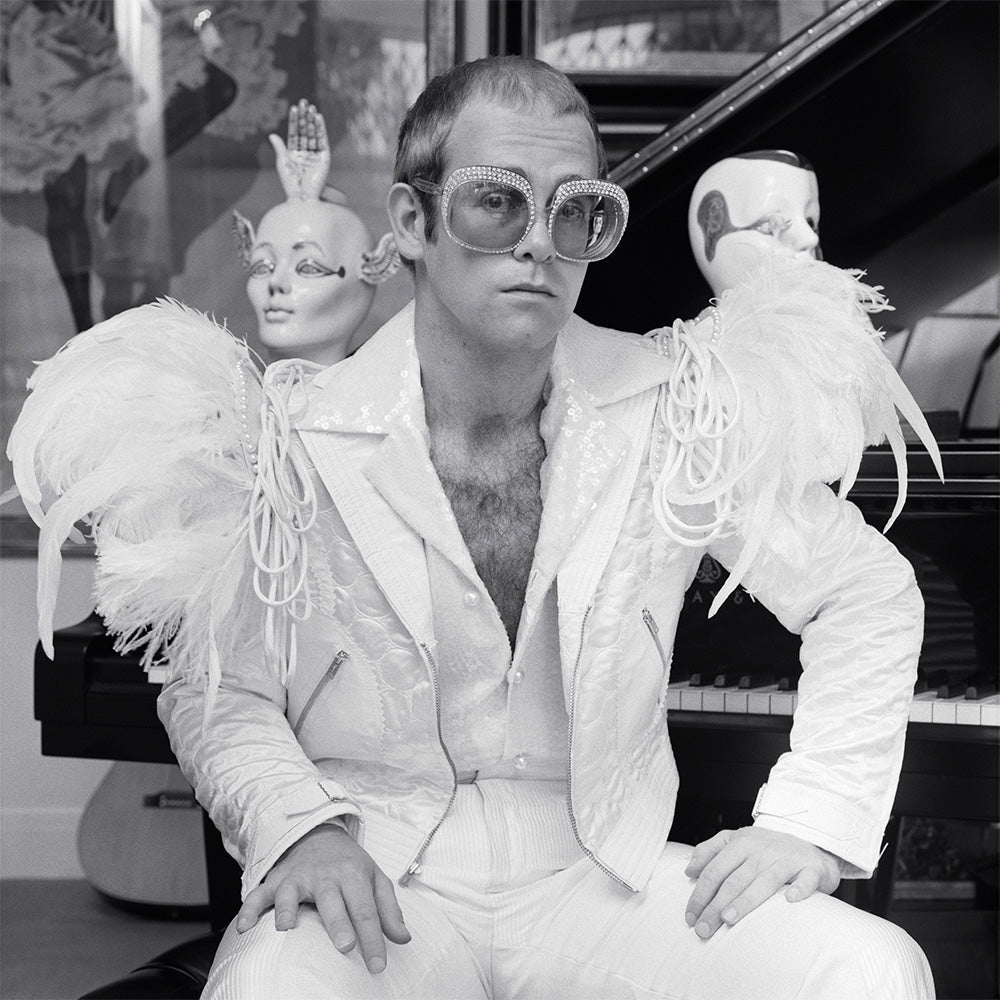 Elton John wearing a white feather suit, circa 1973