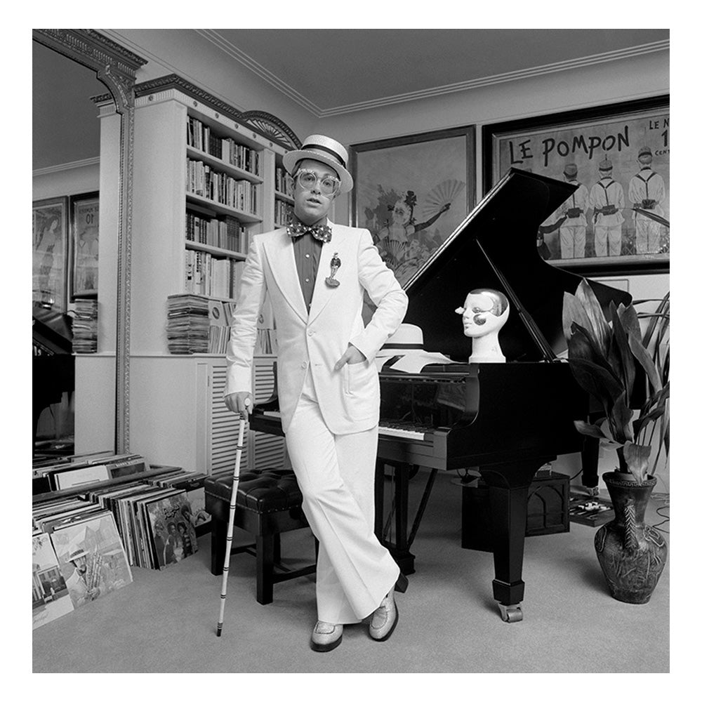 Elton John standing at his piano, 1974