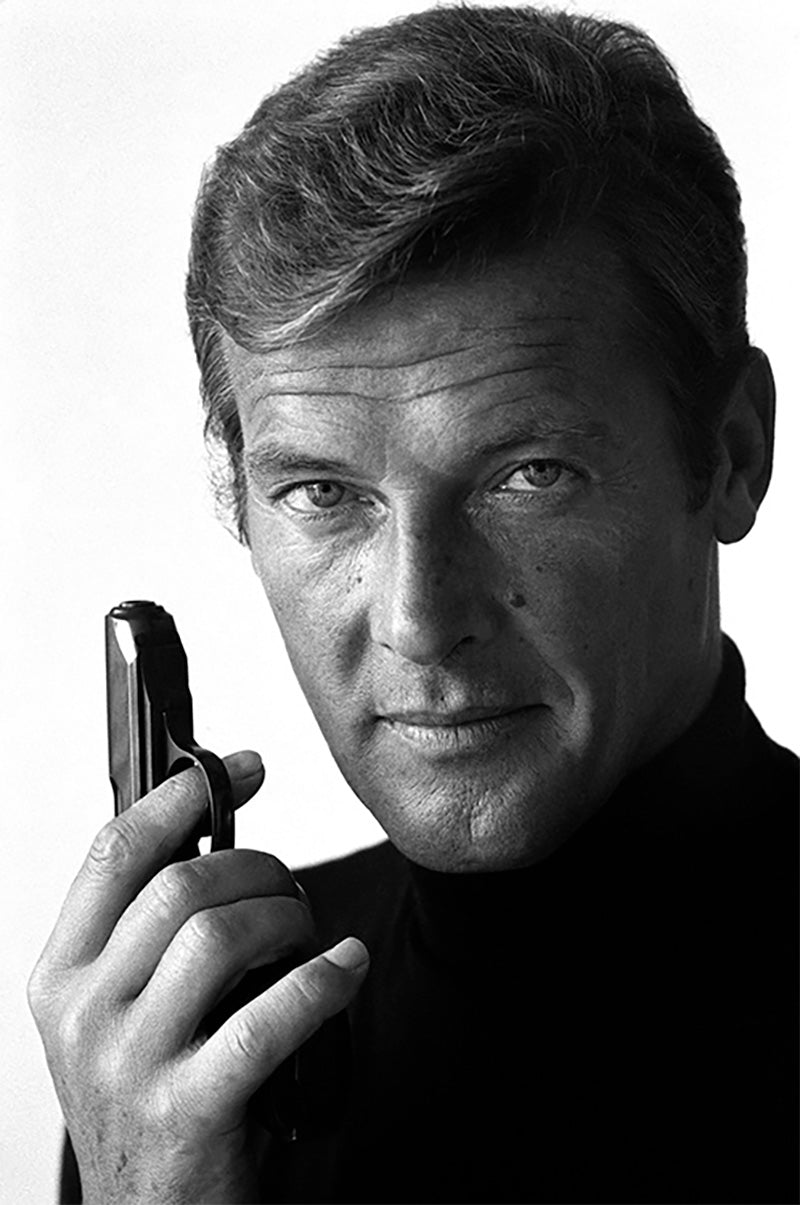 Roger Moore as James Bond poses with his weapon of choice, December 1972